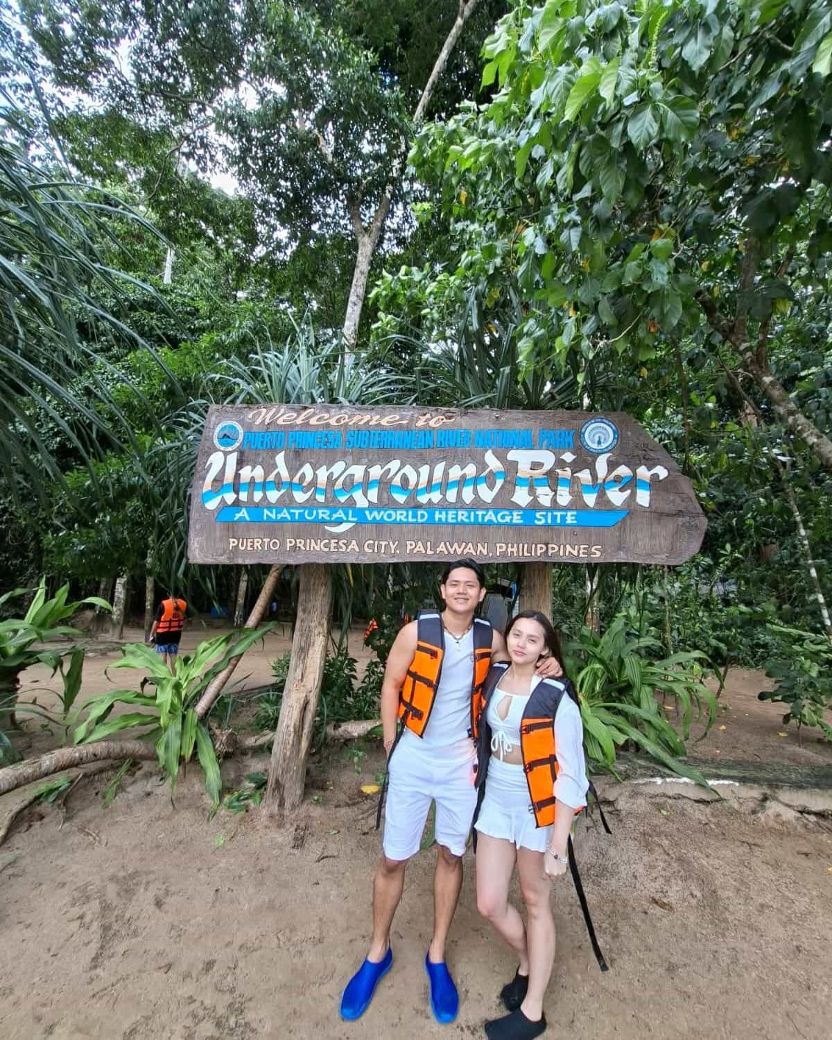 Couple at the Subterranean River sign